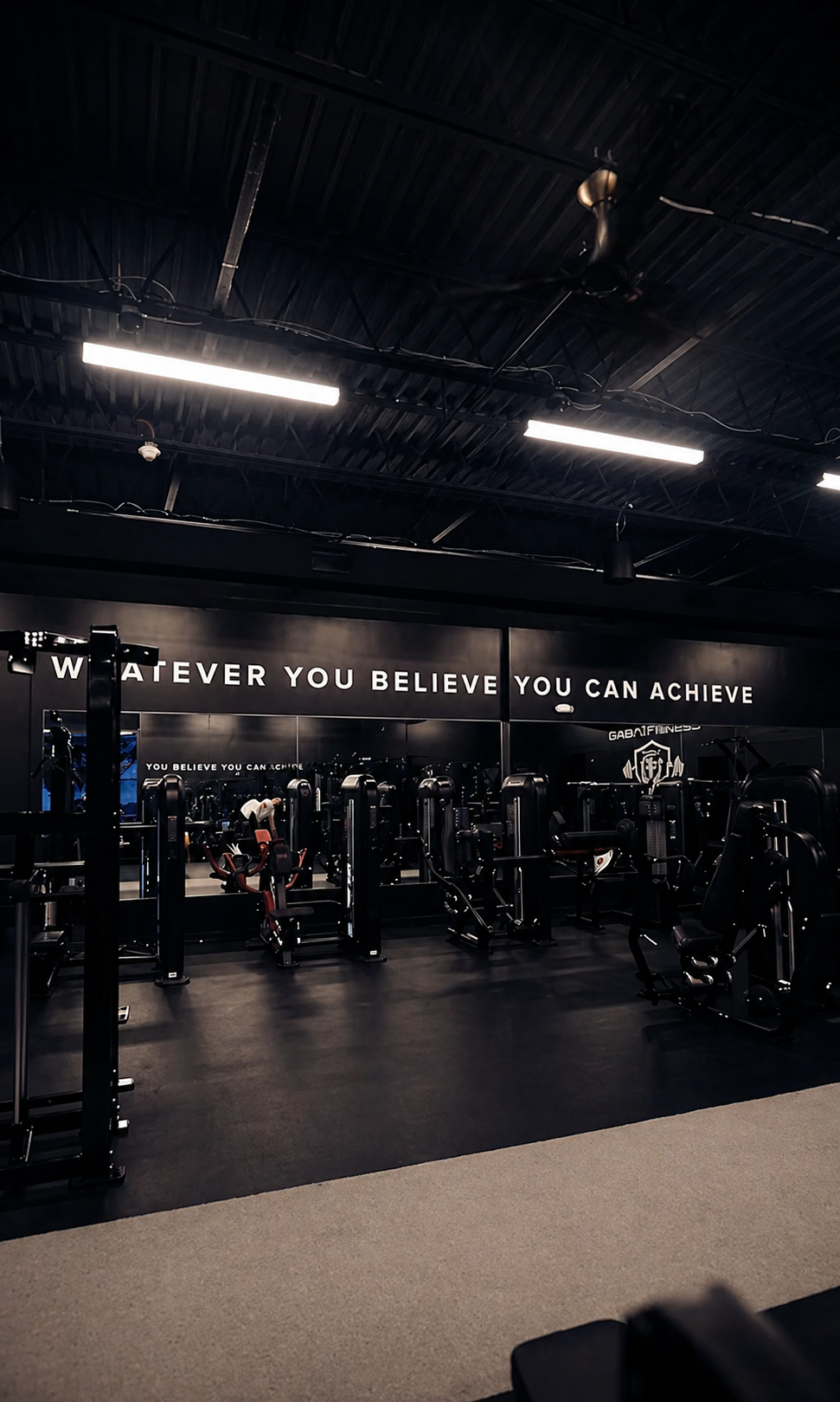 Machine floor with 'Whatever you believe you can achieve' wall lettering